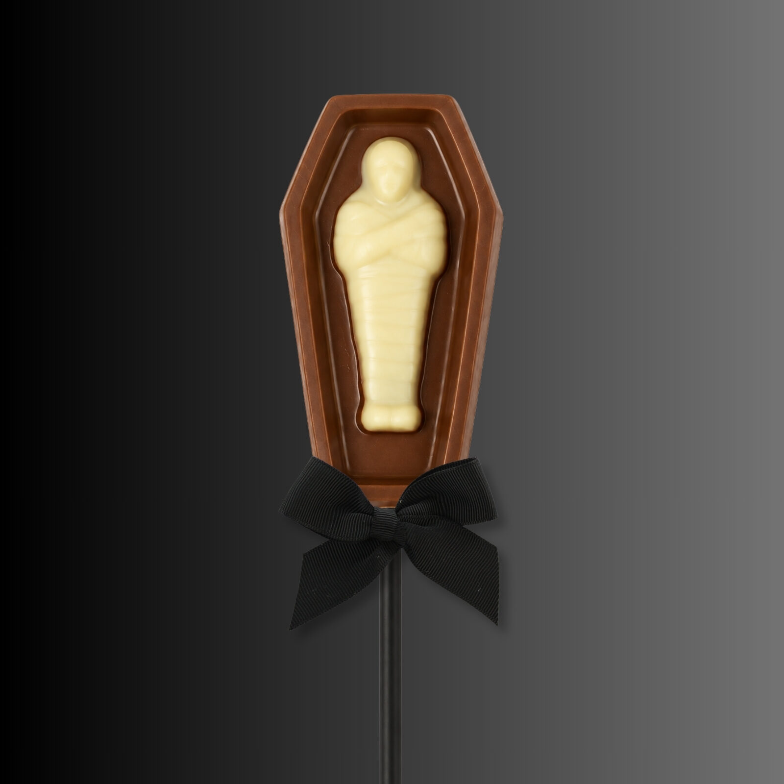 Milk and white chocolate coffin shaped lollipop with inset mummy